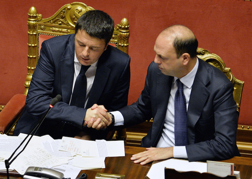 Newly appointed Italian Prime Minister Matteo Renzi (L) is congratulate by Interior Minister Angelino Alfano during a debate for a confidence vote at the Italian Senate  on February 24, 2014 in Rome.Matteo Renzi was to unveil details of his ambitious government programme on Monday as he faced a confidence vote in parliament in a key test of his power to unite warring factions and secure a solid majority. The new premier is expected to present plans for rapidly overhauling the tax system, job market and public administration in his speech to the Senate, which will put his newly-formed cabinet to a confidence vote.    AFP PHOTO / ANDREAS SOLARO        (Photo credit should read ANDREAS SOLARO/AFP/Getty Images)